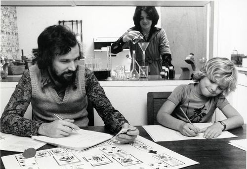 OU students, possibly a couple with their young son, working with home experiment kits in their home.