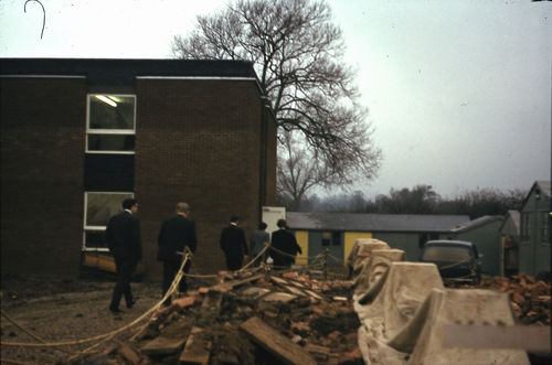 A group of men walking through a construction site on the OU campus