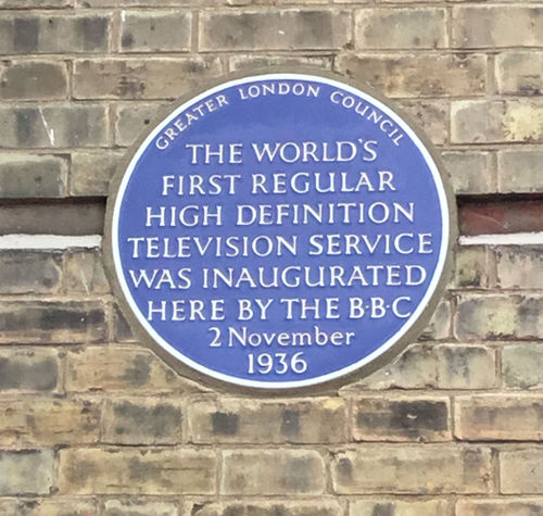 Blue plaque on the exterior wall of Alexandra Palace commemorating the inauguration of the world's first regular HD TV service by the BBC in 1936.   