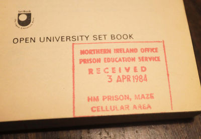 Photograph showing the inside page of an Open University set course book (The Mighty Micro) with a HM Prison Maze Cellular stamp on it dated 3rd April 1984.