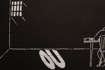 An original drawing by David Smyth for the Time to Think Project. It shows a student studying against a black background with bars through which a light shines throwing an image of the initials 