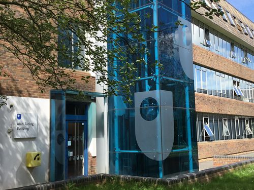 External view of the entrance to the Alan Turing Building on the Open University campus in Milton Keynes. The Building was originally opened as the Mathematics block in 1973. In 2010 it was officially renamed the Alan Turing Building. Alan Turing (1916-1954), described as 'the father of computer science', was a mathematician, logician, cryptanalyst and computer scientist who was a main participant in the code-breaking work at Bletchley Park, not far from the Open University campus.