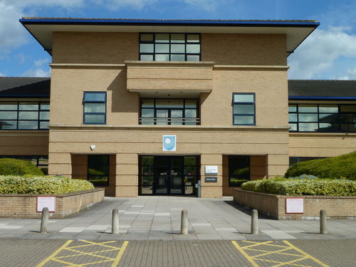External view of the entrance to the Frank Henshaw Building, on the Open University's East Campus in Milton Keynes. Named after Frank Henshaw who was associated with De Montfort University (originally located on the site) and was also a member of The Open University's Council between 1994 and 2002 and Chair of the Estates Committee from 1995 to 2002. 