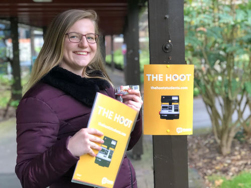 Fanni Zombor, Vice President Engagement 2020-2022, holds a poster promoting the launch of The Hoot.